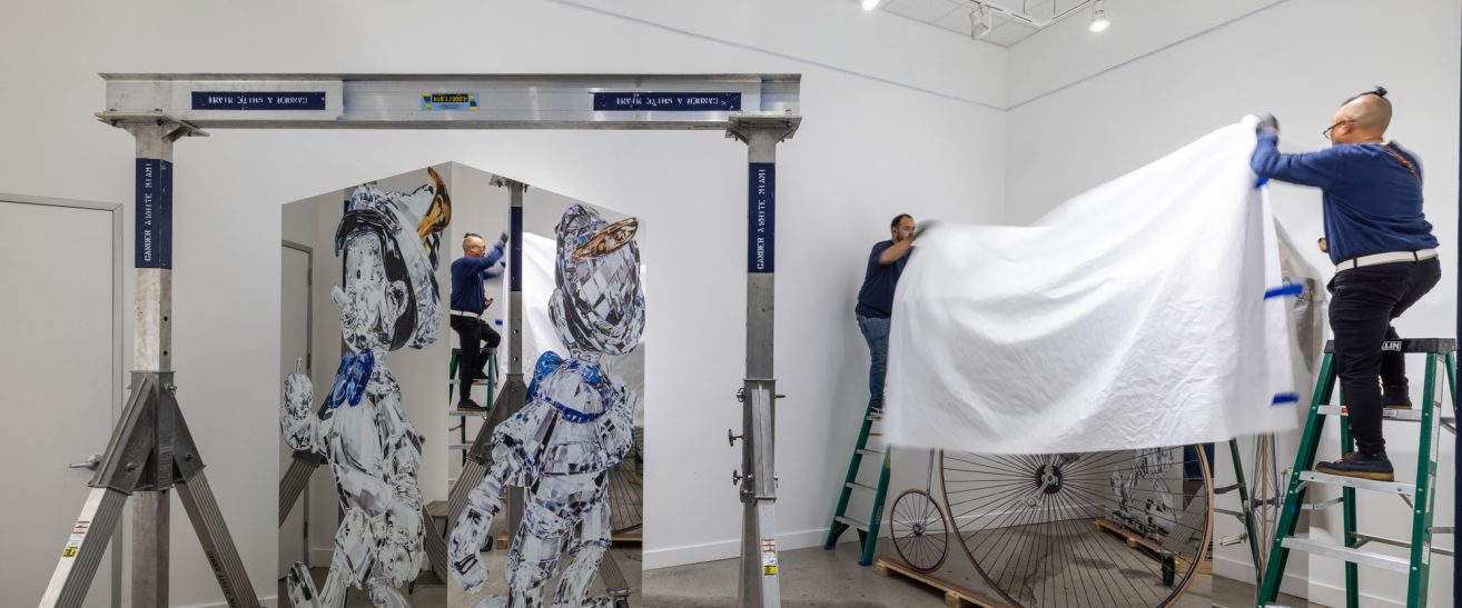 Gander & White expert art technicians install an exhibition sculpture.