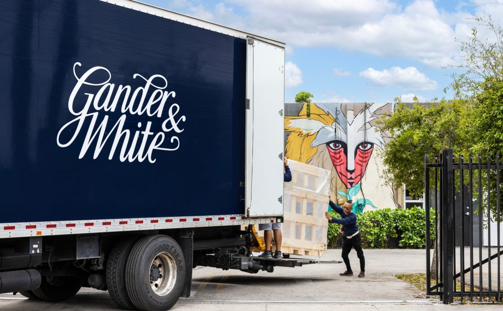Gander and White employee unloading art from Gander and White lorry