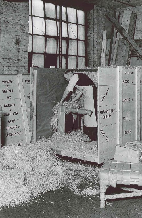 Black and white historical image of Gander and White employees packing up items